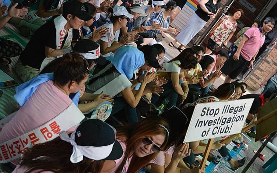 Philippine women who work at many of the bars within the Songtan Entertainment District made up a large portion of the protest rally held outside the main gate of Osan Air Base, South Korea, June 14, 2013. They were protesting the 51st Fighter Wing command's decision to make some bars off-limits