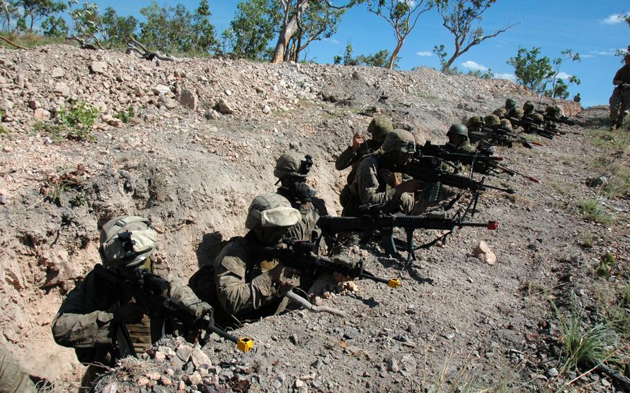 U.S. Marines and Australian soldiers take cover in a trench during an exercise at Mount Bundey Training Area, Northern Territory on Thursday. 

