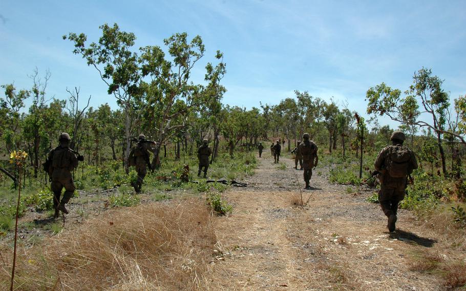 Marines move through Mount Bundey Training Area, Northern Territory, during an exercise with Australian soldiers on Thursday.

