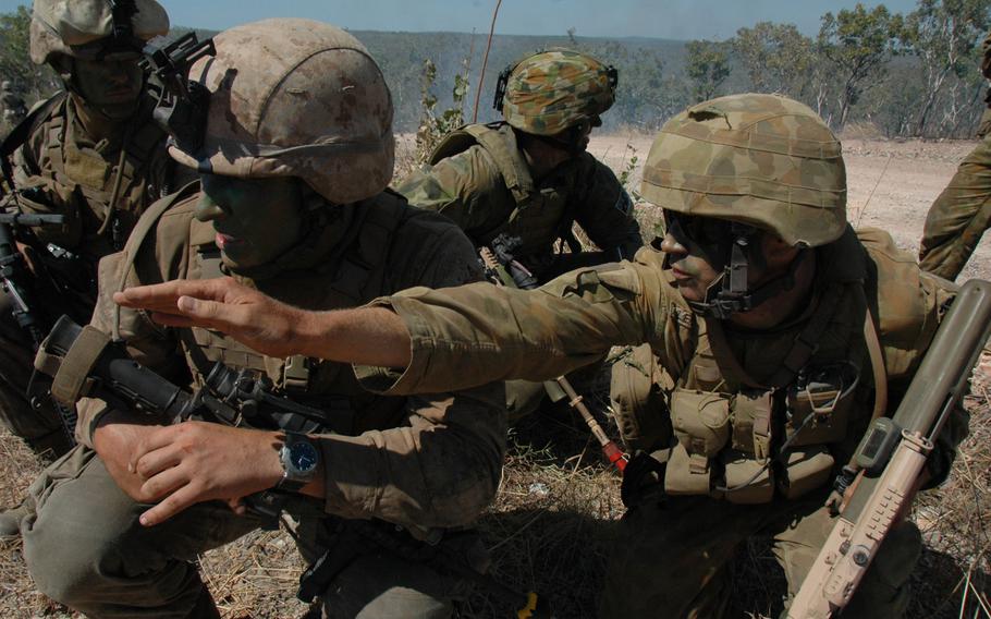 U.S. Marine 1st Lt. Mike Kopa, 26, of Woodbridge, Va., second from left, gets some advice from an Australian soldier at Mount Bundey Training Area, Australia in June.