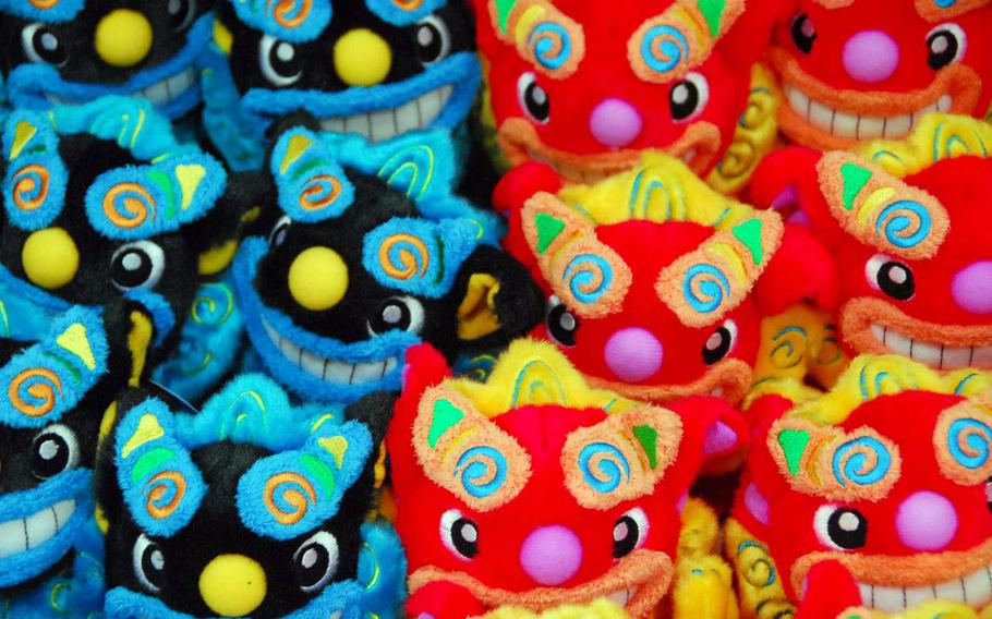 Brightly colored stuffed shisa dogs -- an Okinawa icon -- are sold in the park gift shop.