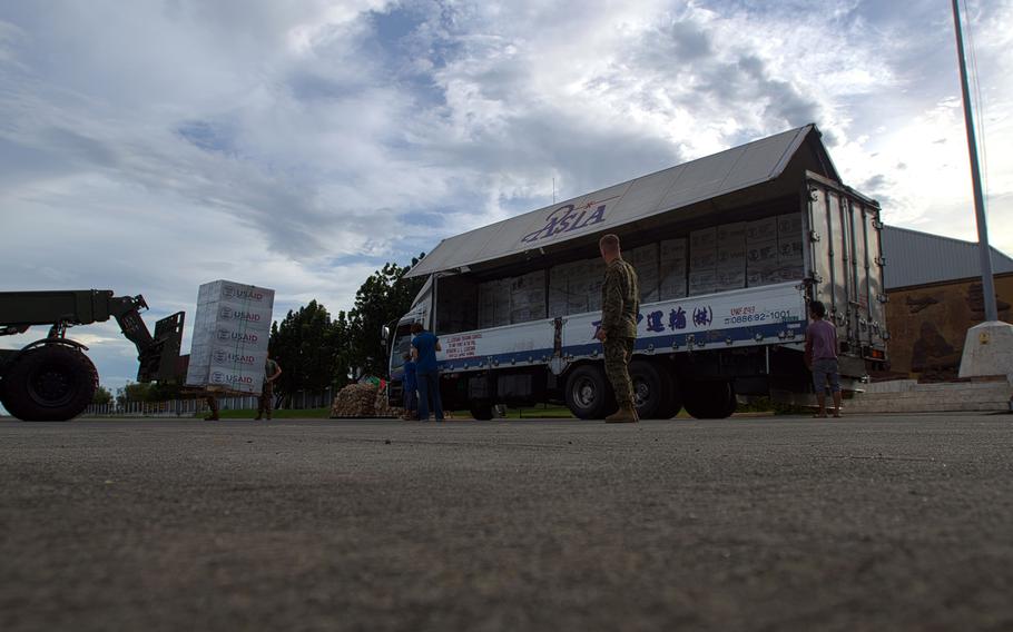 U.S. Marines unload shipping pallets containing aid packages sent that will be delivered to those in the Philippines affected by Super Typhoon Haiyan.