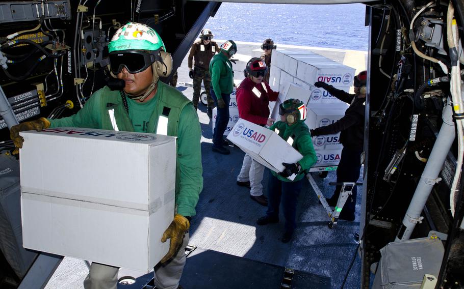 Sailors load relief packages onto a V-22 Osprey as it prepares to leave the USS George Washington to deliver supplies to victims of Super Typhoon Haiyan, Nov. 18, 2013.

Eric Guzman/Stars and Stripes