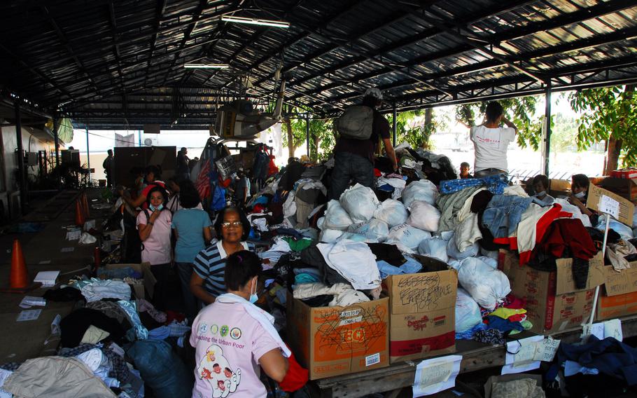 Volunteers at Villamor Air Base in Manila separate piles of donated clothing that will be given to Typhoon Haiyan evacuees from Tacloban and the surrounding areas. The U.S. military has flown nearly 11,600 evacuees to Villamor since the storm hit earlier this month.