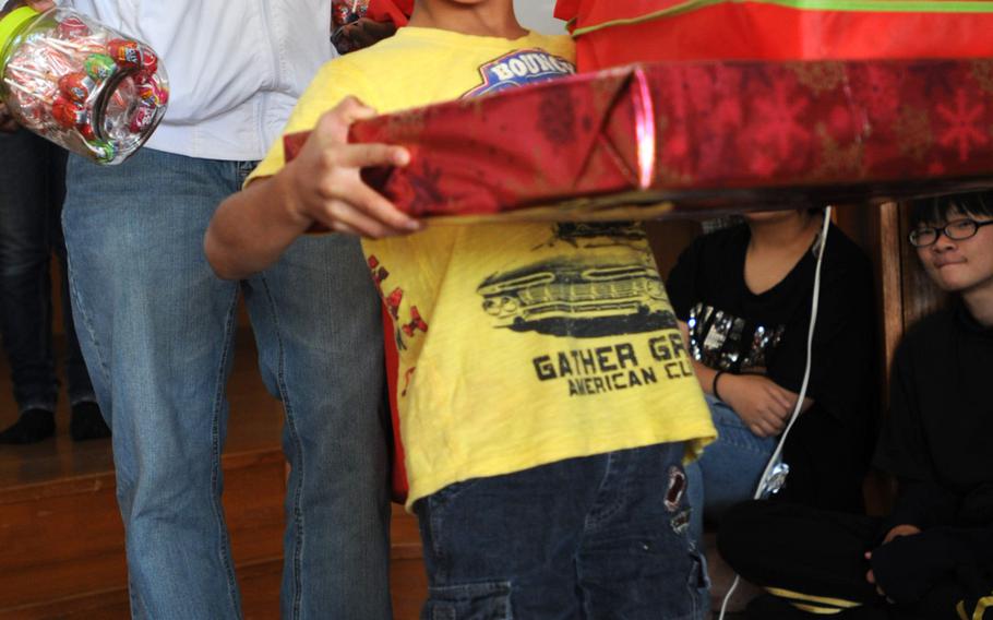 Children celebrate their gifts from the Marines and family members of 3rd Intelligence Battalion during a Christmas gift giving at the Nagomi Nursing Home for Children in Kin, Okinawa, Dec. 23, 2013. 

Lisa Tourtelot/Stars and Stripes