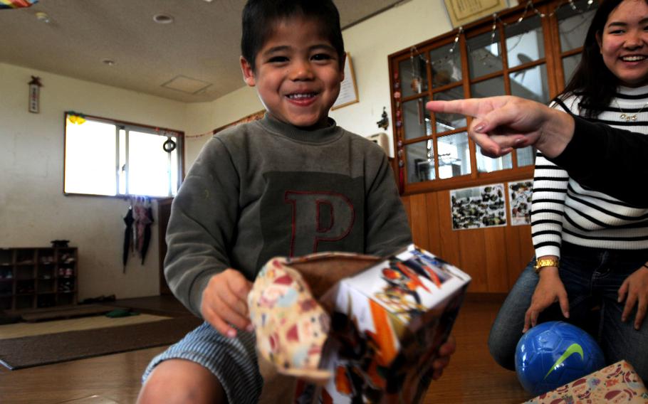 Children celebrate their gifts from the Marines and family members of 3rd Intelligence Battalion during a Christmas gift giving at the Nagomi Nursing Home for Children in Kin, Okinawa, Dec. 23, 2013. 

Lisa Tourtelot/Stars and Stripes