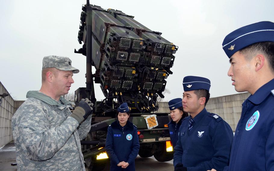 Capt. Edward Ellingson, public affairs officer for the 35th Air Defense Artillery Brigade, explains the U.S. Patriot missile system to Republic of Korea air force cadets during their visit to Osan Air Base, South Korea, Jan. 21, 2014. Nearly 100 cadets took part in the trip.