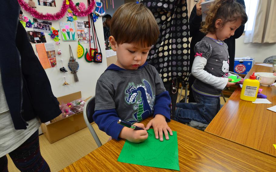 Kaito Sullivan, 3, and his sister Serina, 5, create art projects while visiting residents of a temporary housing complex in Minamisoma, Japan. Military families have been supporting the residents, who were displaced by the March 2011 disasters, through the group Helping Hands For Tohoku.