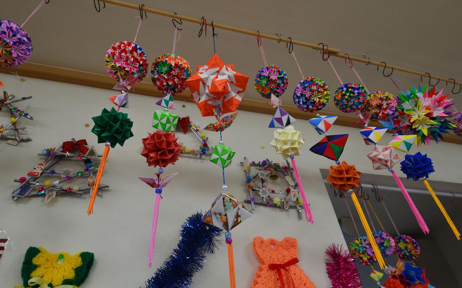Origami that the residents of the temporary housing complex at Minamisoma shared with military families two years ago still hangs in the community room.