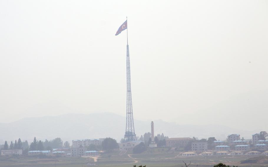The North Korean flag flies high above the blue roof buildings in Kijongdong, North Korea, May 28, 2014.