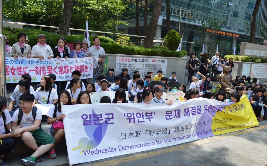 Adults and children hold a protest across the street from the Japanese Embassy in Seoul, South Korea, on May 21, 2014. Koreans regularly protest the embassy over Japan forcing women into sexual slavery during World War II.