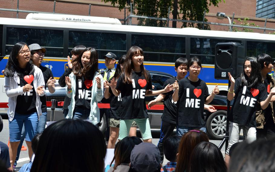 Korean children sing a song during a protest across the street from the Japanese Embassy in Seoul, South Korea, on May 21, 2014. A protest is held every Wednesday over the issue of Korean women forced into sexual slavery by Japan during World War II.