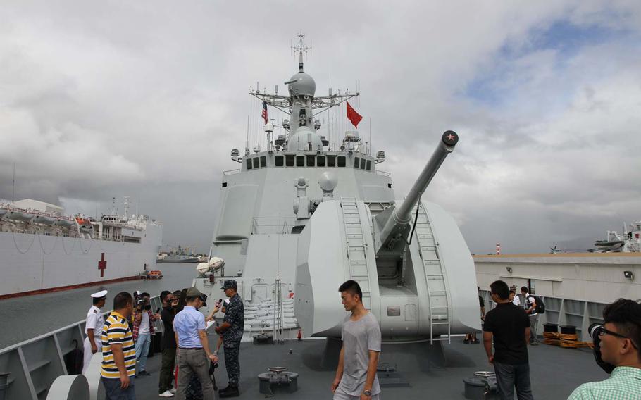 Reporters and other visitors gather to inspect the bow of the Haikou, a Chinese destroyer that arrived in Honolulu in June 2014 for participation in the annual Pacific Rim exercises. This was the first year China sent ships to the exercise from its navy, which the country has dramatically modernized and expanded during the past decade.
