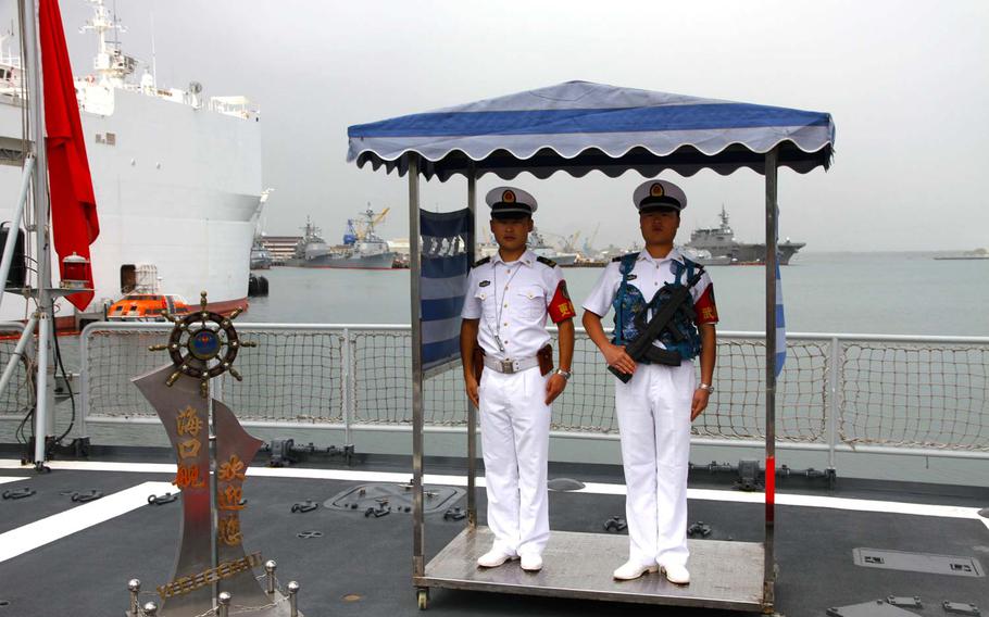 Chinese sailors stand guard on the stern of the Haikou, China's flagship destroyer sent to Honolulu for the Pacific Rim exercises in June 2014. 