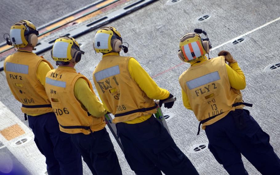 Crewmen of the ROKS Dokdo stand on deck to observe a Marine MV-22 Osprey on March 26, 2015. The South Korean sailors worked to tie down and then release the U.S. Marine Corps aircraft.


