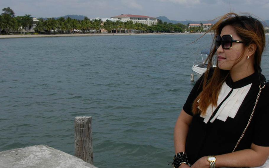 Marilou Laude, whose transgender sister, Jennifer, was found dead after checking into an Olongapo hotel with a U.S. Marine on Oct. 11, 2014, stands on a jetty in Subic Bay, Philippines, near Pier One, a beachfront bar and restaurant frequented by American personnel before Jennifer Laude's death.
