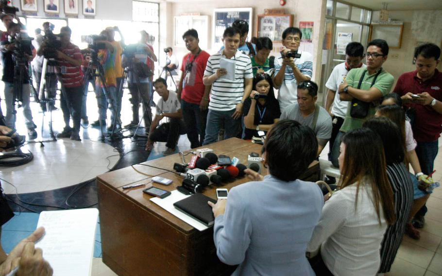 Virgie Suarez, center left, an attorney for the late Jennifer Laude's family, and family members talk to journalists during the trial of U.S. Marine Pfc. Joseph Scott Pemberton, who is accused of the killing of Laude in October 2014.