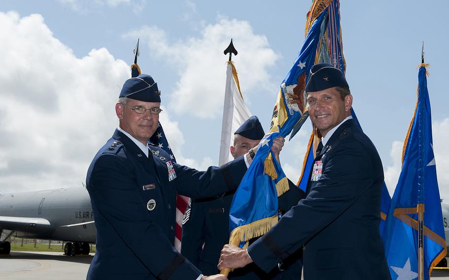 Brig. Gen. Barry Cornish, 18th Wing commander, right, receives the guidon from Lt. Gen. Sam Angelella, U.S. Forces Japan commander, during the 18th Wing change-of-command ceremony at Kadena Air Base, Okinawa, on April 2, 2015.