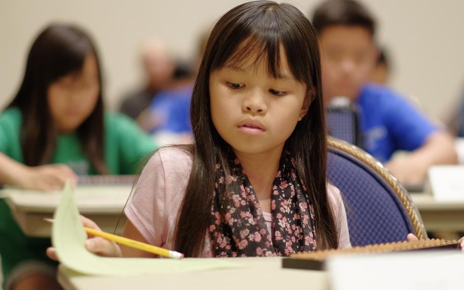 Jessica Phung reviews her answer to a complex math problem during the DODEA Pacific Japan District's 33rd annual Soroban Contest at the New Sanno Hotel in Tokyo on May 13, 2015.