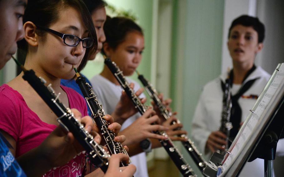 Students of the Moanalua Middle School band receive training from Petty Officer 3rd Class Alia Moroz, an oboist with the Pacific Fleet Band, during a music educational clinic earlier this year at the Pu'u Kahea Conference Center on Oahu, Hawaii. Based in Pearl Harbor, the band provides professional-level music and entertainment in support of the U.S. Navy's recruiting programs and for public relations in the U.S. and abroad.