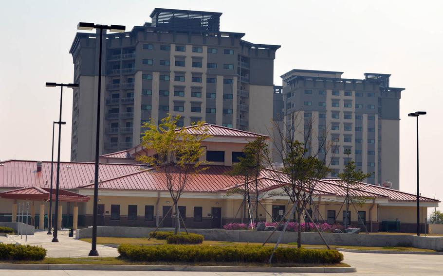 A child development center, foreground, still under construction with two recently built and occupied apartment towers behind it at Camp Humphreys, South Korea, on April 24, 2015.