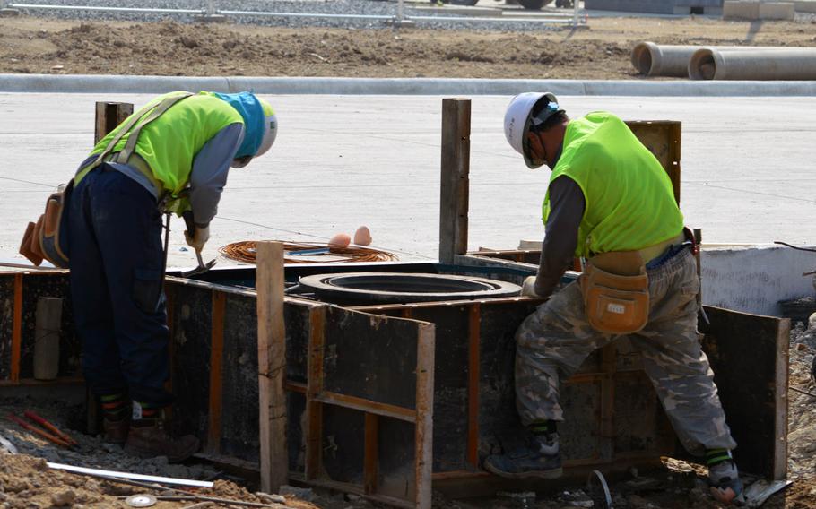 South Korean construction workers set up a formwork around a sewer entrance at Camp Humphreys, South Korea, on April 24, 2015.