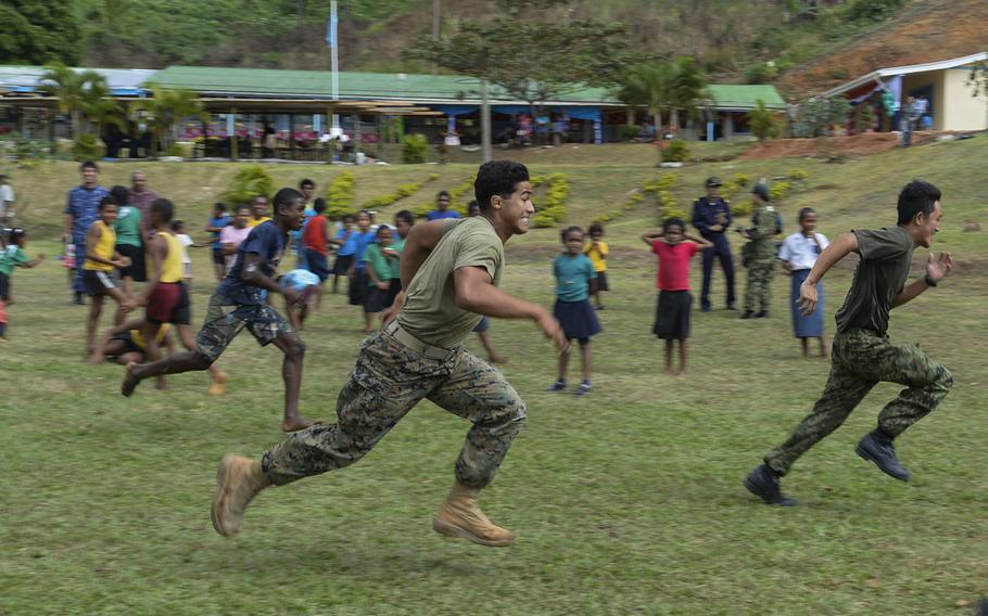 Cpl. Lucas Ferreira participates in a relay race at the Viani Primary School in Fiji during Pacific Partnership, June 17, 2015.