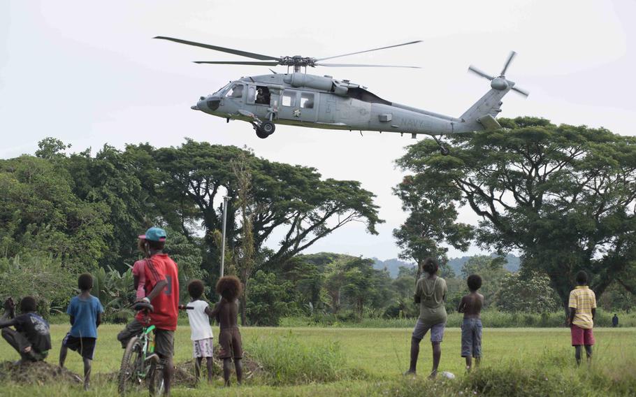 An MH-60S Knight Hawk helicopter attached to Helicopter Sea Combat Squadron 21 takes off from the Pacific Partnership 2015 landing area in Arawa, Papua New Guinea June 27, 2015.