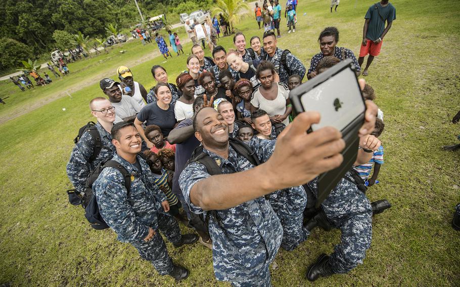 Command Master Chief Dedrick Walker, attached to the Military Sealift Command hospital ship USNS Mercy, takes a group selfie during Pacific Partnership, June 28, 2015. Mercy was  in Papua New Guinea for its second mission port of Pacific Partnership.