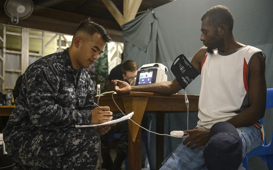 Hospital Corpsman 2nd Class John Villanueva, assigned to the Military Sealift Command hospital ship USNS Mercy, takes a patient's blood pressure during a Pacific Partnership 2015 surgical screening at St. Mary's Hospital, July 6, 2015. Mercy was in Papua New Guinea for its second mission port of Pacific Partnership. 

Mark El-Rayes/U.S. Navy