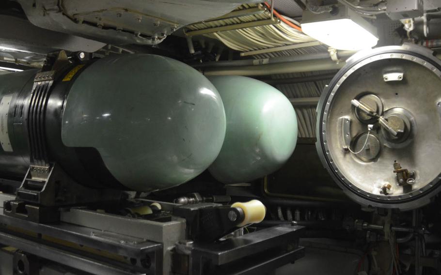 Two of the USS Michigan's Mk-48 torpedoes lie next to one of the submarine's tubes, as displayed during a port visit at Yokosuka Naval Base, Japan, on July 10, 2015. Two of the tubes can launch both torpedoes and Tomahawk cruise missiles. The two forward-most missile tubes were permanently converted to lock-out chambers that allow underwater deployment and retrieval of special operations personnel.