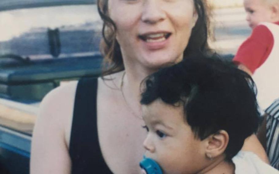 Emi McGowan holds her son in this undated file photo. McGowan, who has three children, has recently reconnected with her father, James Walker, who has spent nearly 46 years looking for her. A sailor assigned to Japan in late '60s, Walker shipped off to Vietnam and never saw his daughter again.