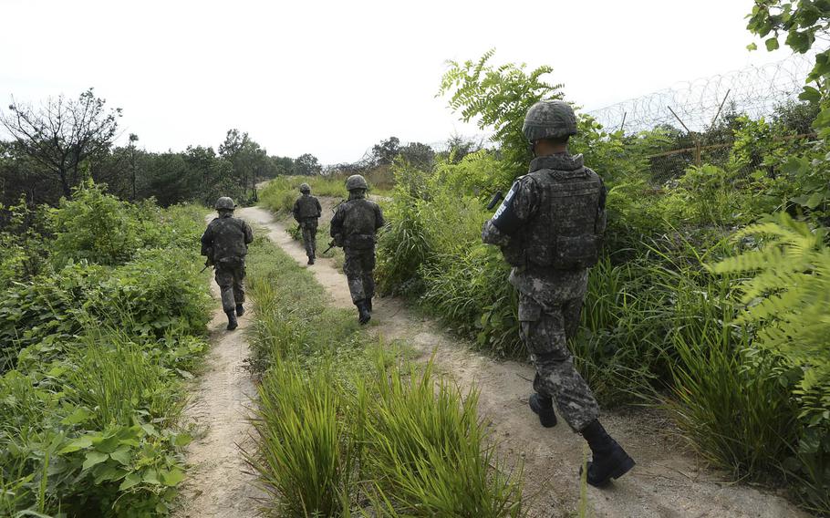 South Korean army soldiers patrol near the scene of a blast inside the Demilitarized Zone near Paju, South Korea, Aug. 9, 2015. North Korean soldiers laid three mines that exploded last week at the border and maimed two South Korean soldiers.