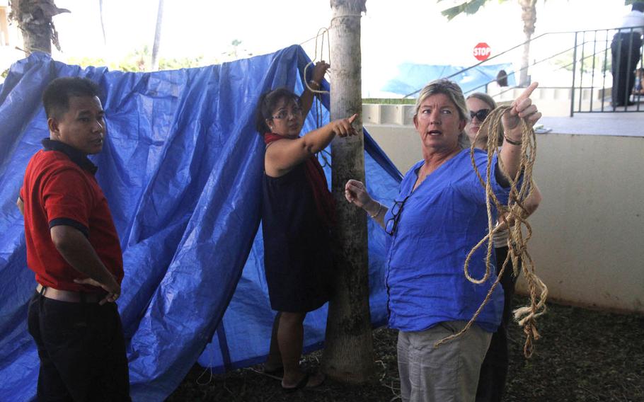 Manoj Thokar, left, a trainer with the Nepal Red Cross, works with his five-member team to construct a makeshift shelter Aug. 19, 2015, during an exercise at the Center for Excellence in Disaster Management and Humanitarian Assistance on Ford Island, Hawaii.