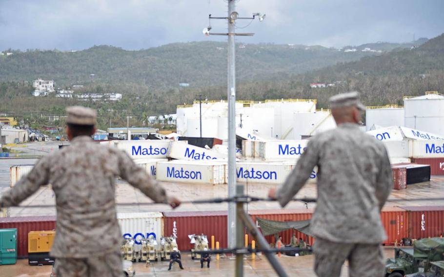 Marines from the 31st Marine Expeditionary Unit aboard amphibious dock landing ship USS Ashland look on Aug. 8, 2015, at  damage caused by Typhoon Soudelor in Saipan. Ashland left Saipan Sunday Aug. 23, 2015, ending weeks of relief assistance to the island.