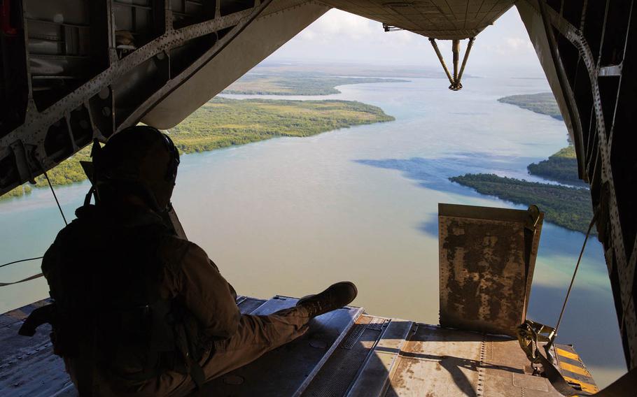 A U.S. Marine rides in a CH-53E Super Stallion with Marine Heavy Helicopter Squadron, 463, Marine Rotational Force - Darwin while flying over the Daly River, Northern Territory, Australia, during Exercise Kowari 15, Aug. 31, 2015. Kowari is environmental survival training hosted by Australia that includes the U.S., Australia and China.
