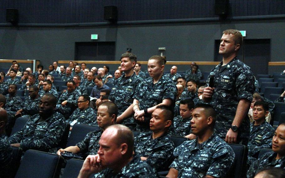 Chief Petty Officer Jennifer Brett, standing on left, and Petty Officer 1st Class Rachel Thao wait to ask questions at an open forum with Master Chief Petty Officer of the Navy Michael Stevens at Yokosuka Naval Base, Japan, on June 22, 2015. Servicemembers like Brett and Thao, who both have active-duty husbands, must choose one parent to "sponsor" their children under regulations covering overseas service.