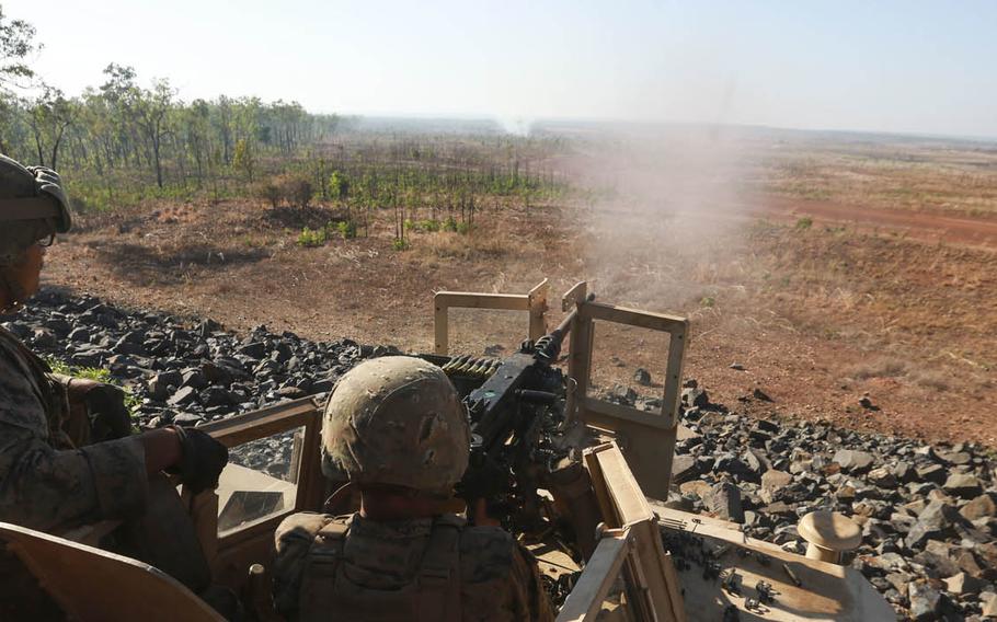 U.S. Marine Corps Cpl. Nicholas Kraut directs Lance Cpl. Trevor Simonidis as he shoots a .50-caliber M2 Browning machine gun during Exercise Crocodile Strike Aug. 18, 2015, at Mount Bundey Training Area, Northern Territory, Australia.