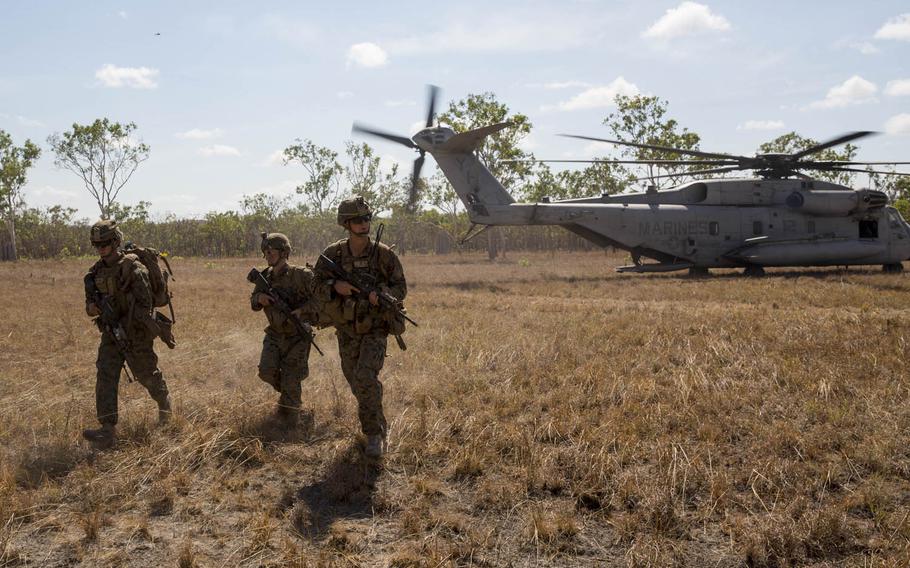 U.S. Marines with Company C, 1st Battalion, 4th Marine Regiment, Marine Rotational Force-Darwin disembark a CH-53E Super Stallion helicopter during an air assault course Aug. 24, 2015, at Mount Bundey Training Area, Northern Territory, Australia.
