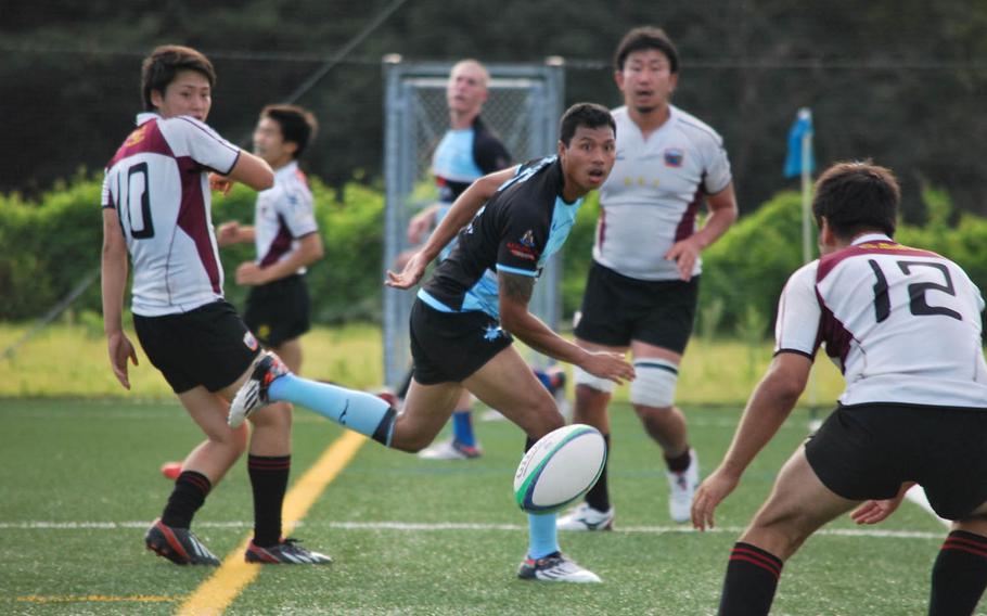 Air Force Staff Sgt. Jerry Sysourath, 28, of Warroad, Minn., center, plays for the Tokyo Crusaders in a rugby match Sunday, Sept. 20, 2015, against Koryo RFC in Kanagawa Prefecture, Japan. Koryo's players are mostly second- and third-generation Koreans whose parents and grandparents came from both North and South, said manager Kim Myong-jun.
