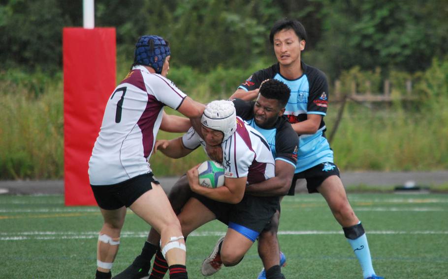 Airman 1st Class Pierre Sims of the Tokyo Crusaders tackles a Koryo RFC player Sunday, Sept. 20, 2015, during a rugby match in Kanagawa Prefecture, Japan. Koryo RFC is a a club made up of former students from North Korean schools in Japan.