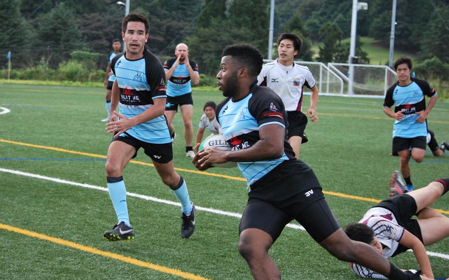 Airman 1st Class Pierre Sims of the Tokyo Crusaders runs with the ball Sunday, Sept. 20, 2015, during a rugby match against Koryo RFC, which includes players who have ties to North Korea, in Kanagawa Prefecture, Japan. 