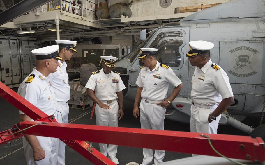 Cmdr. Christopher Brown, commanding officer of the USS Fort Worth, center, speaks with officers from the Indian navy and Japan Maritime Self-Defense Force on Wednesday, Oct. 14, 2015, as part of Exercise Malabar 2015. This year's training, which runs through Oct. 19, focuses on surface and anti-submarine warfare, air defense and search-and-rescue tactics.