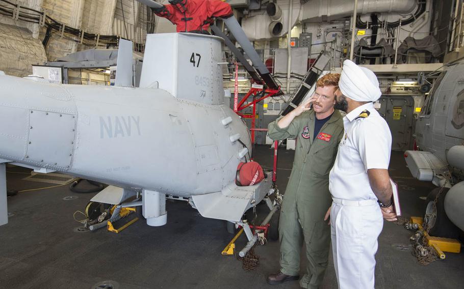 Lt. James Stranges, left, speaks Wednesday, Oct. 14, 2015, with an Indian navy officer about the MQ-8B Fire Scout drone during a tour of the USS Fort Worth as part of Exercise Malabar 2015.