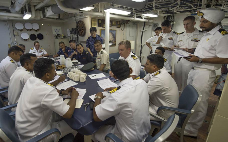 Officers from the U.S. and Indian navies and the Japan Maritime Self-Defense Force meet Monday, Oct. 12, 2015, on the USS Fort Worth ahead of Exercise Malabar 2015. Malabar, a series of complex, high-end war games that began in 1992, traditionally involves just the U.S. and India. Japan took part as a guest in the past and became a permanent member this year.