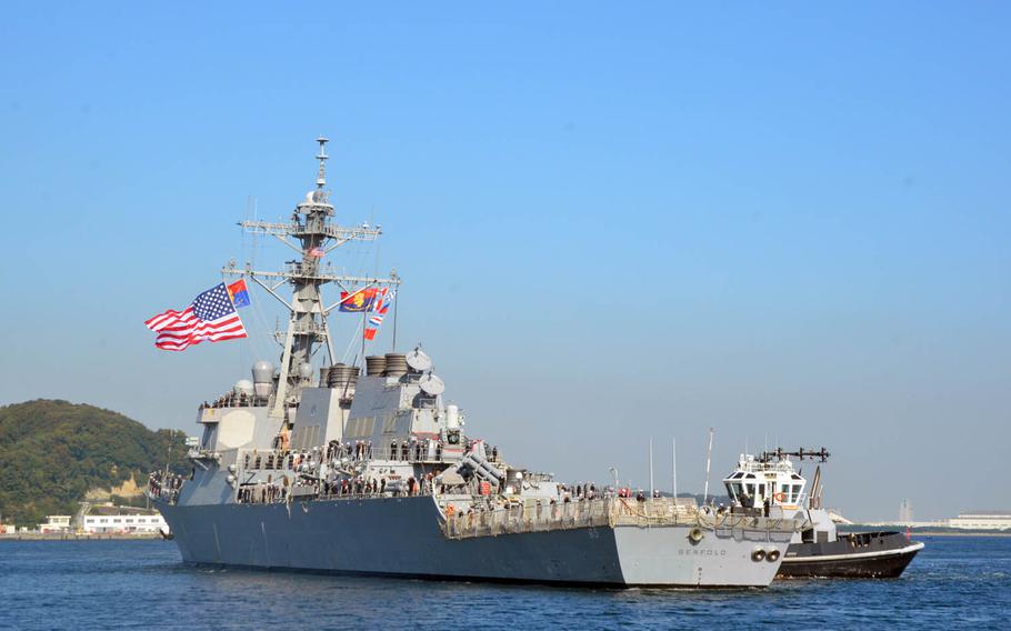 The destroyer USS Benfold, aided by a tugboat, arrives Monday, Oct. 19, 2015, at its new homeport at Yokosuka Naval Base, Japan. Benfold recently underwent several upgrades, including an updated version of its ballistic missile defense system.