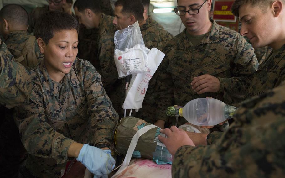 Navy Lt. Cmdr. Lorelie P. Flinn treats a patient during a shock trauma drill, part of Blue Chromite 2016, Monday, Oct. 26, 2015, on Okinawa, Japan. Flinn, a critical-care nurse with 3rd Medical Battalion, 3rd Marine Logistics Group, is assisted by Navy Petty Officer 3rd Class Caleb Alkire, a team leader with Company B, 3rd Medical Battalion, and Petty Officer 3rd Class Ryan T. Badillo, also a team leader with the company. The shock trauma drill gave the Navy medical team an opportunity to practice stabilizing patients in an expeditionary setting.