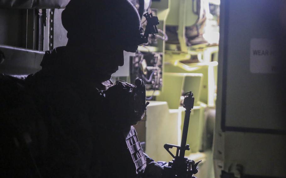 Cpl. David Vargas-Merlo waits calmly in the darkness of an amphibious assault vehicle before rushing into an attack, Monday Oct. 26, 2015, on Okinawa, Japan, during Blue Chromite 2016. Blue Chromite is a large-scale exercise led by the 4th Marine Regiment. Each element of III Marine Expeditionary Force is represented in Blue Chromite.