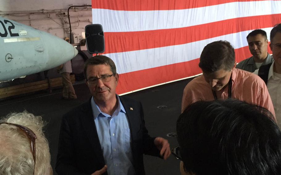 Secretary of Defense Ash Carter speaks to reporters aboard the USS Theodore Roosevelt as it sails in the South China Sea on Thursday, Nov. 5, 2015.