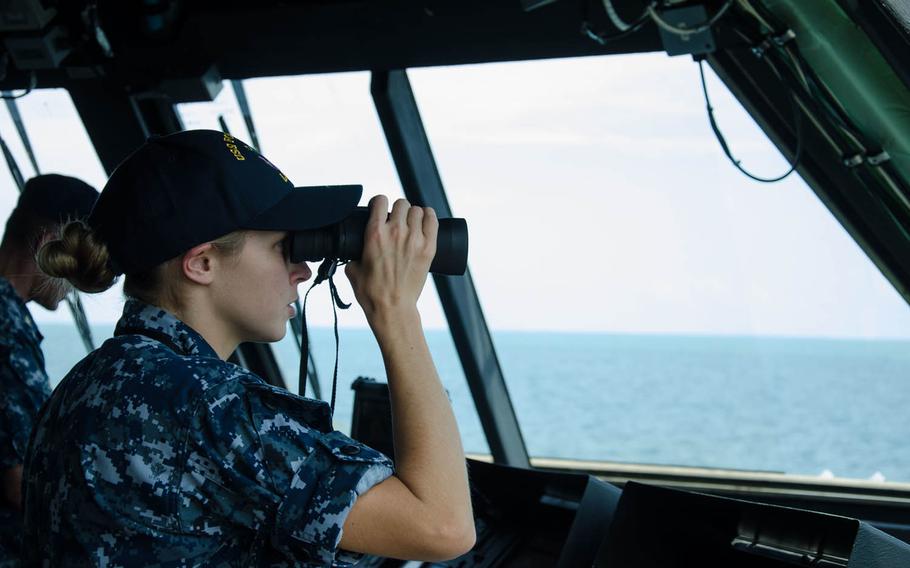 Lt. j.g Clare Lyons watches for contacts on the bridge aboard the USS Fort Worth as the littoral combat ship arrives in Sihanoukville, Cambodia, Sunday, Nov. 15, 2015, for Cooperation Afloat Readiness and Training Cambodia 2015. CARAT is a blend of shore-based exchanges and operational exercises that feature a wide range of naval operations, including surface, undersea, aviation and amphibious warfare.